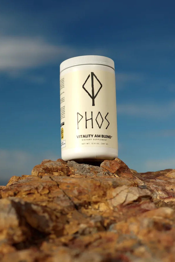 Phos Vitality AM Blend container outdoors against a morning sky