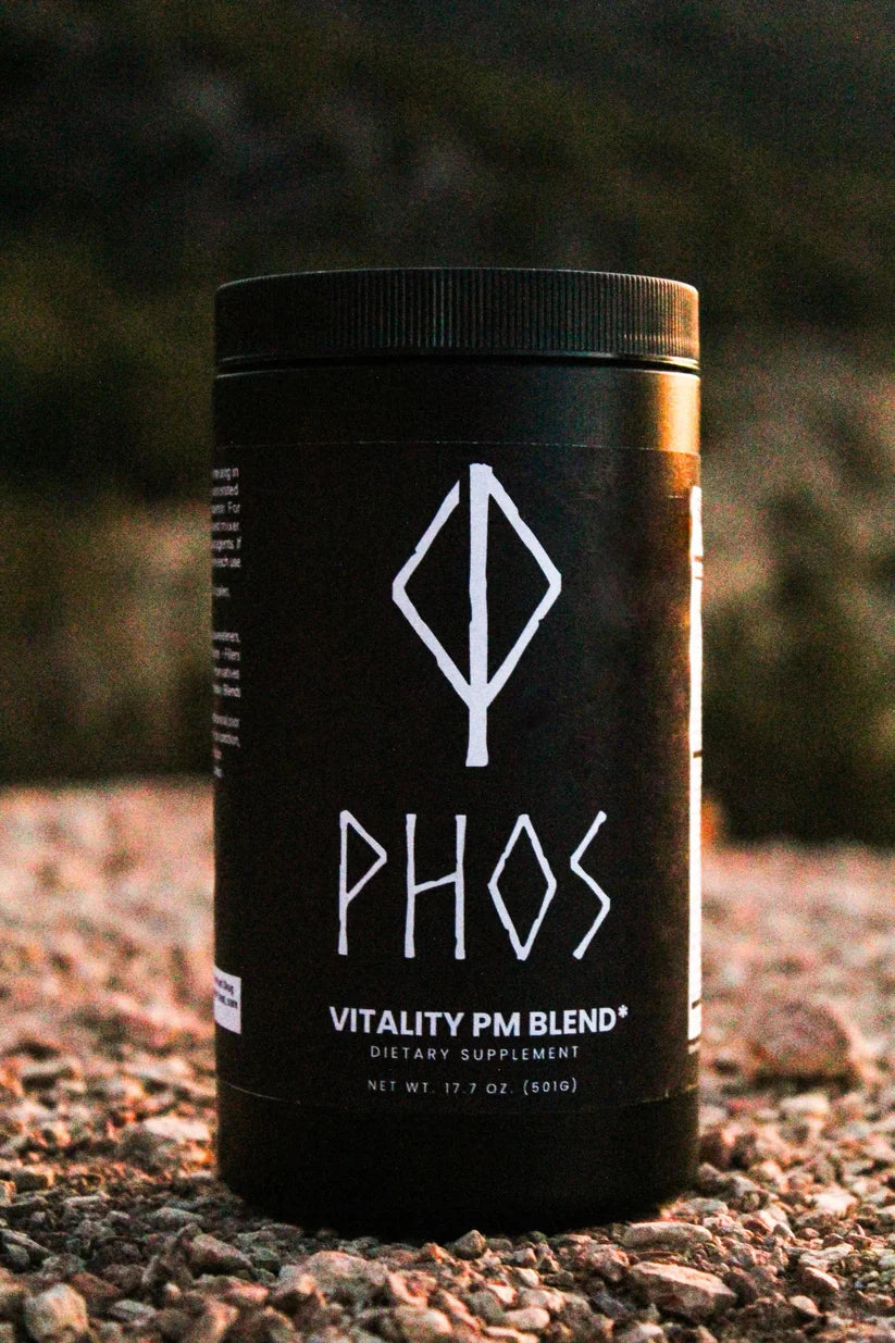 Phos vitality PM blend dietary supplement container placed outdoors on gravel ground